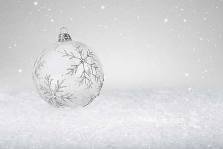 Clear Glass Christmas Bauble on fake white snowの写真素材