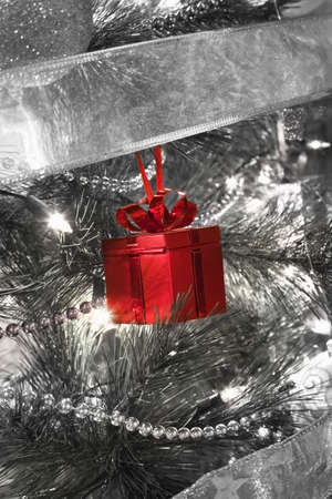 close up of Christmas present shape tree decoration on a illuminated Christmas treeの写真素材