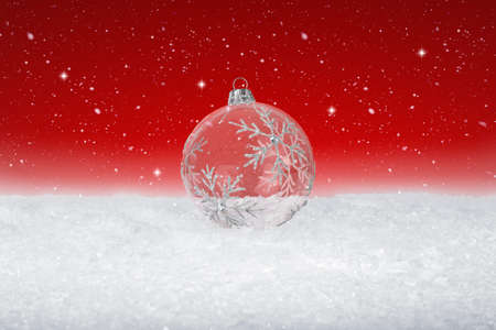 Clear Glass Christmas Bauble on fake white snowの写真素材