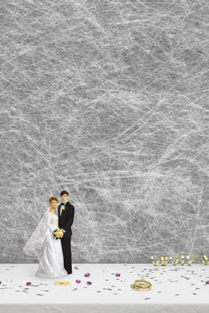 bride and groom wedding cake toppers & party decorations on a white table clothの写真素材
