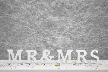 Mr & Mrs wooden sign & party decorations on a white table clothの写真素材