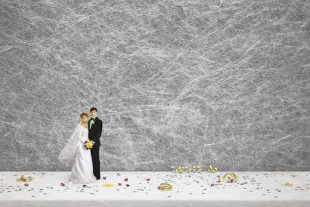 bride and groom wedding cake toppers & party decorations on a white table clothの写真素材