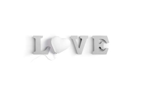 Wooden letters spelling LOVE with a heart shaped white balloonの写真素材
