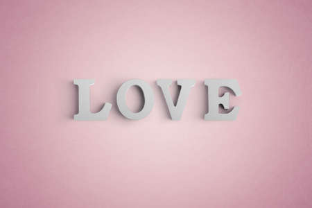Wooden letters spelling LOVE with a heart shaped white balloonの写真素材