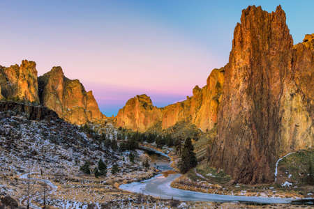 Winter sunrise at Smith Rock State Park with a dusting of snow and a frozen Crooked River.の写真素材