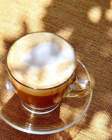 A foamed coffe on a table, shot from above の写真素材