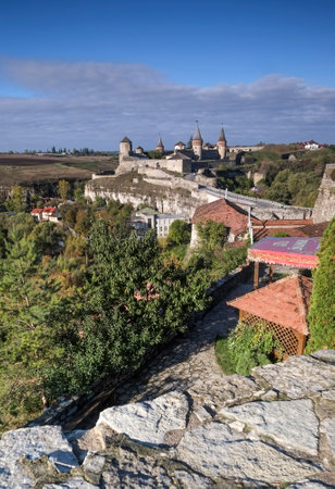View of the Most Zamkowy and Castle of Kamianets-Podilskyi in Western Ukraine taken on a sunny autumn day. The cobbled street leads the eye across the bridge to the castleのeditorial素材