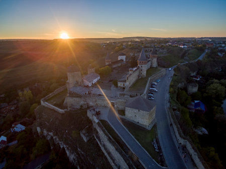 Aerial shot towards a sunset behind Kamianets-Podilskyi castle in Western Ukraine. Taken on a clear autumn eveningのeditorial素材