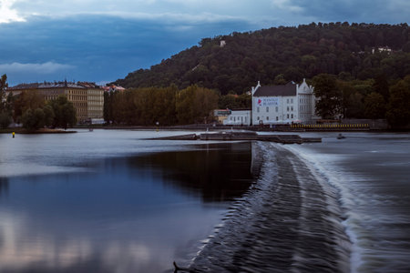 Fast flowing weir on the River Vltava near the Charles Bridge in Prague. Taken at sundownのeditorial素材