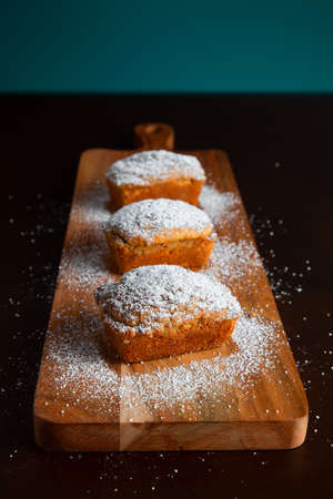 Fresh baked sweet bread loaves made for breakfast or dessert covered in white powdered sugar.