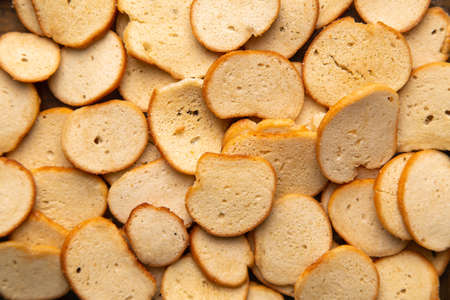 A closeup horizontal image of delicious golden toasted bagel chips.