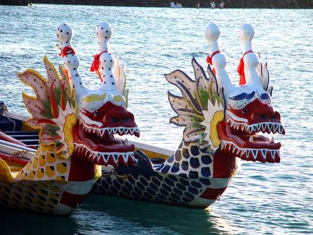 Two dragon boats rest in the sea.の写真素材