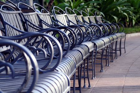A row of chairs in a park like setting.の写真素材