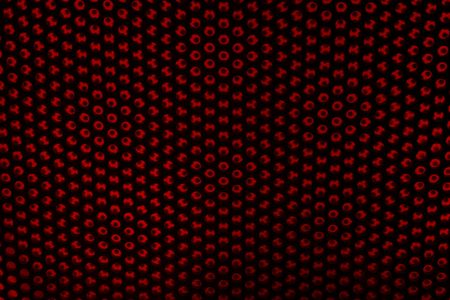 A metal grate with color showing throughの写真素材