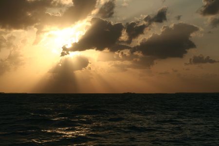 A dramatic sunset and the light and shadows from the clouds.の写真素材