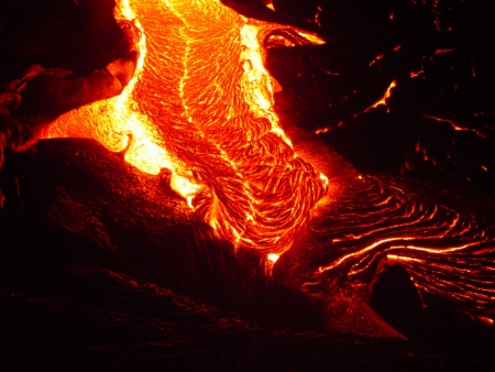Pele braids are easily seen in this image of flowing lava. Pele braids are easily seen in this image of flowing lava.