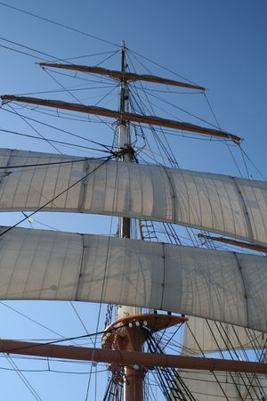 Look up at the canvas, mast, and rigging of a tall ship sails.の写真素材