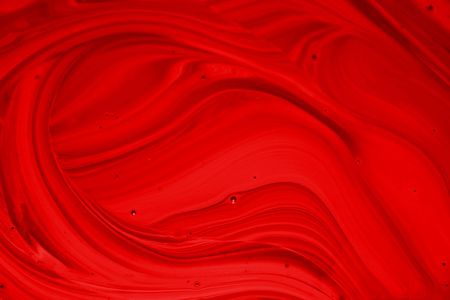 Thick, bright red liquid in motion. の写真素材