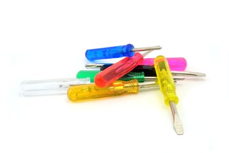 A pile of small hand tools with multicolored, florescent handles.の写真素材