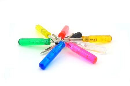 A pile of small hand tools with multicolored, florescent handles.の写真素材