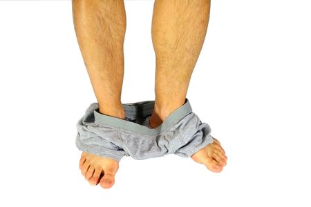 A man with his underwear around his ankles, isolated on white.の写真素材
