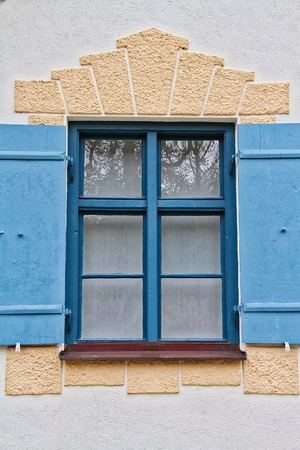 A German style window with blue shutters.の写真素材