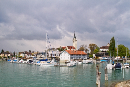 A church and harbor in Romanshorn Switzerland from the lake.のeditorial素材