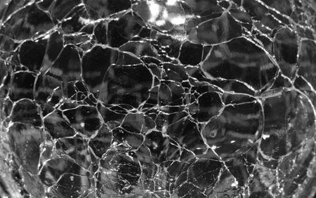 Detail of a sphere of cracked glass with back light.