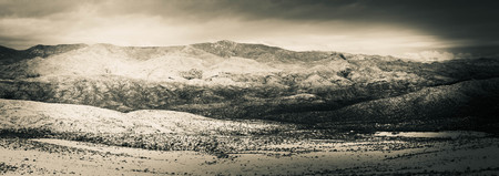 The desert of Arizona covered in snow with distant mountains.の写真素材