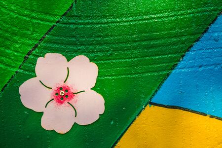 A flower background painted on aged, textured concrete.