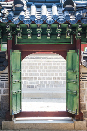 A traditional Korean Gate with open green doors.のeditorial素材