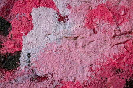 Abstract background in pink shades on a very rough and textured background.の写真素材