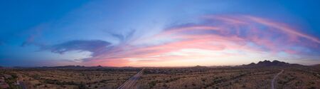 Panoramic aerial view of a desert community in Arizona during the golden hour at sunset.の写真素材