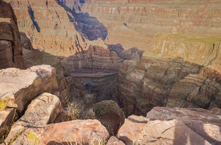 Looking down into the Grand Canyon at the Colorado River flowing below in the late afternoon sun.の写真素材