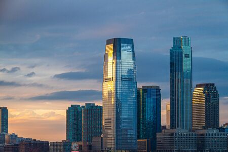 Evening image of the skyline of Jersey City in the state of New Jersey during sunset.の写真素材