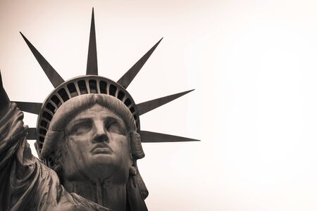 Looking up at the Statute of Liberty with a neutral background.の写真素材