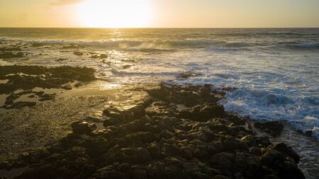 Sunrise over the Pacific Ocean from the Ke One Kula Lookout at Wawamalu Beach Park in Hawaii.の写真素材
