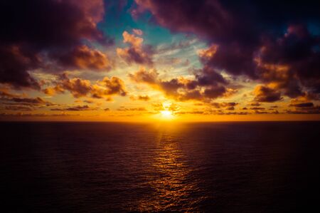 A dramatic sunrise over the Pacific Ocean from the Hawaiian islands.の写真素材