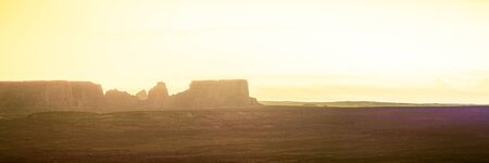 Panoramic image of the morning sky over a barren desert with mesas in the distance near Page, Arizona.の写真素材