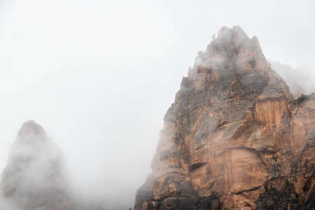 The mountain peaks of Zion National Park piercing through and overcast sky creating neutral space to add text or graphics.の写真素材