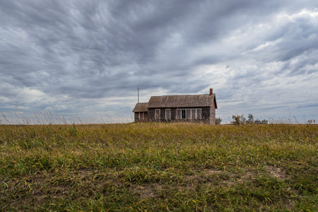 An old, abandoned school house sitting in the middle of the great plains of North Dakota.の写真素材