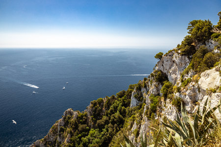 Looking at the Mediterranean Sea for a high vantage point with the summit of a rocky peak in the forground on a bright sunny day.の写真素材