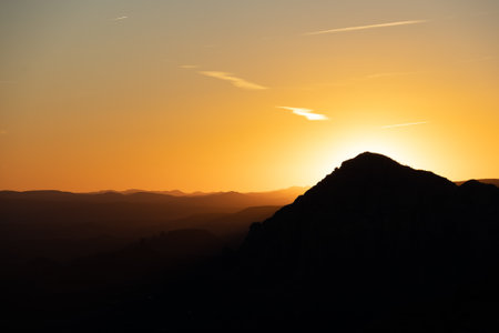 Dramatic sunset over the mountains of Sedona Arizona with layers of mountains in the distance.の写真素材