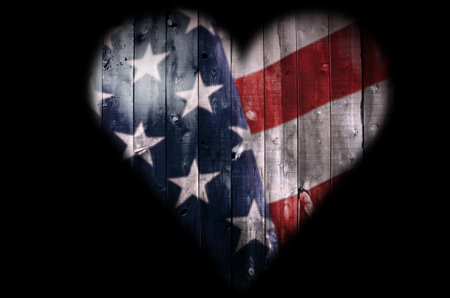 An American Flag in the shape of a heart on a black background.の写真素材