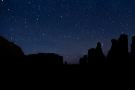 The night sky over the desert rock formations of Utah in Arches National Park.の写真素材