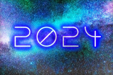 The date 2024 in glowing numbers on cosmic background of stars for New Years.