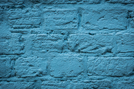 A blank blue brick wall that is heavily weatheblue with plenty of copy spaceの写真素材