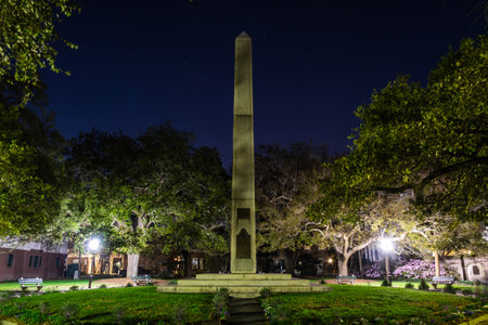 The haunted Washington Square in Charleston, South Carolina at night illuminated by the park lights.の写真素材