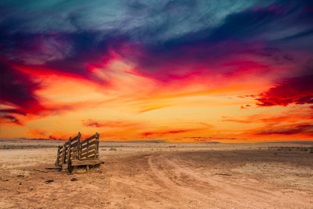 An old corral, abandoned in the desert of Arizona under an eening sky with bright colorful clouds.の写真素材