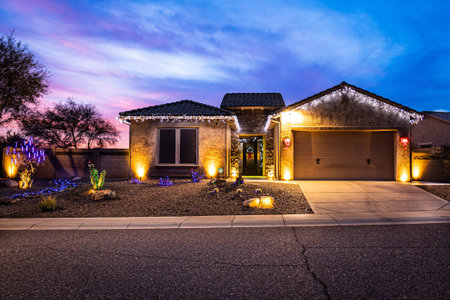 A home decorated with Christmas Lights with a dramatic evening sky in the background.の写真素材